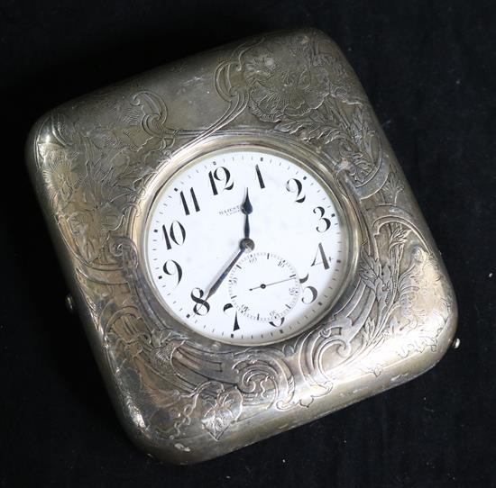 An American sterling silver travelling watch case with large nickel cased Majestic pocket watch. 12.5cm.